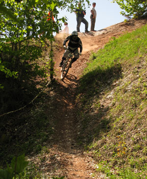 A man riding a mountain bike down a dirt trail.